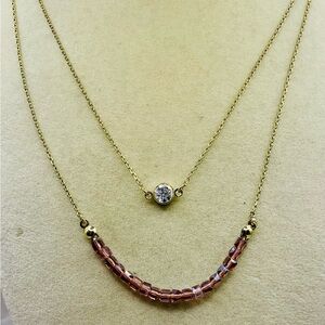 Layered gold tone Necklace with Purple Crystals and a Clear Rhinestone Pendant